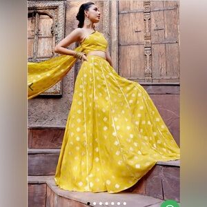 Yellow foil print Lehenga with one shoulder blouse and attached drape